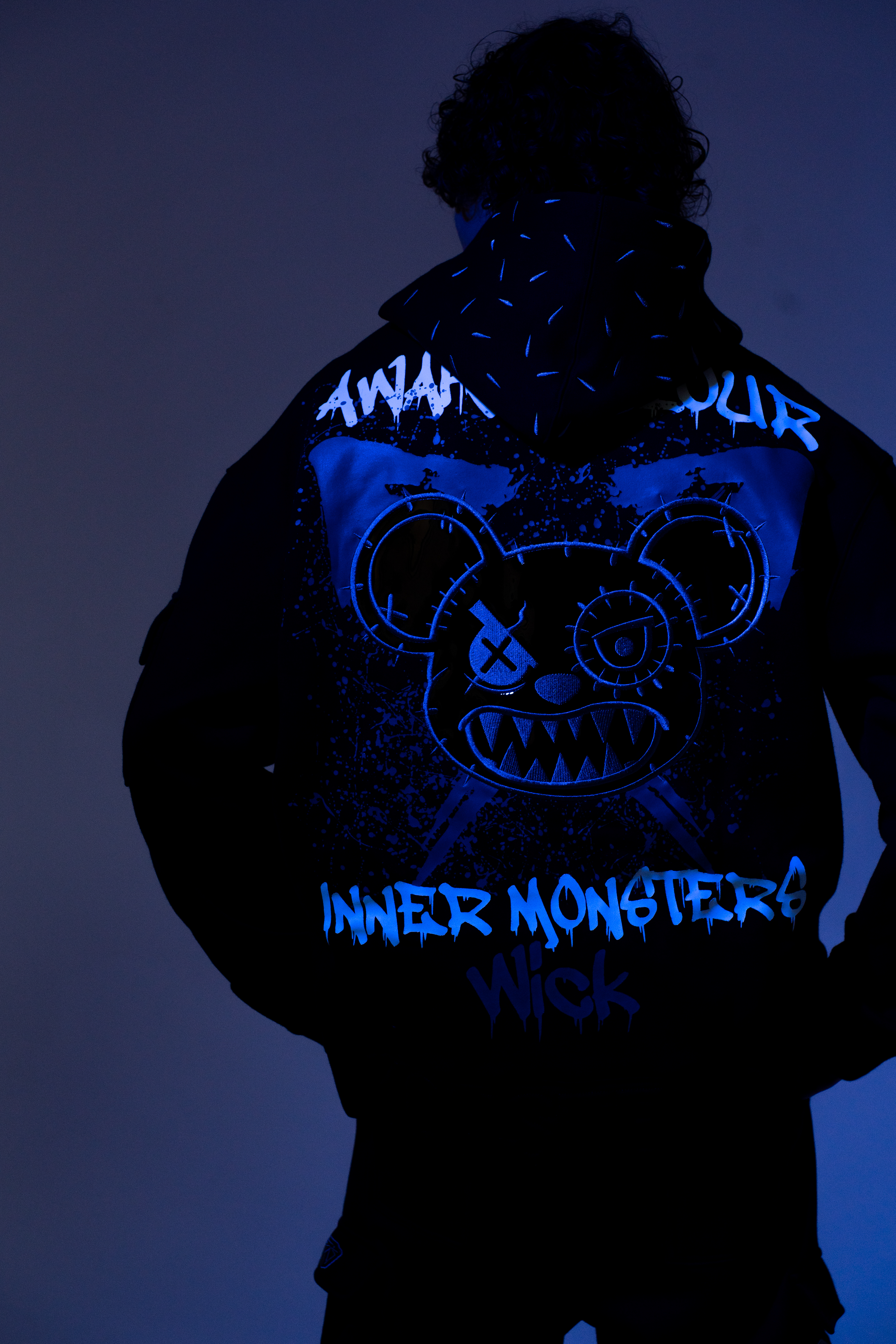 Neon ICE UV shoot — black hoodie detail